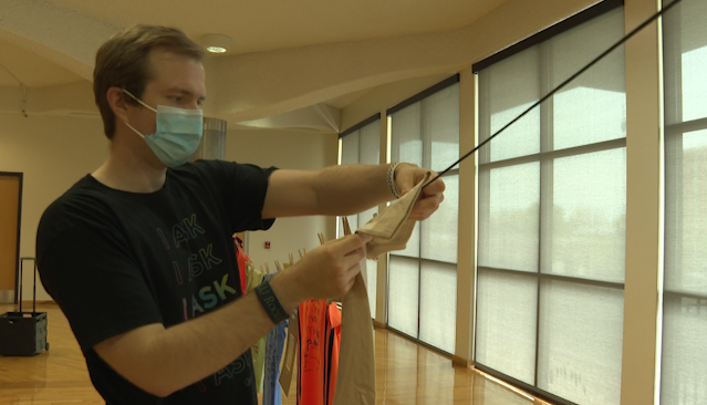 Mealy hanging up one of the several shirts on the clothesline